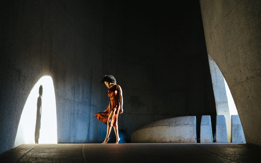 Taal monument spotlight on girl wearing brown dress in south africa