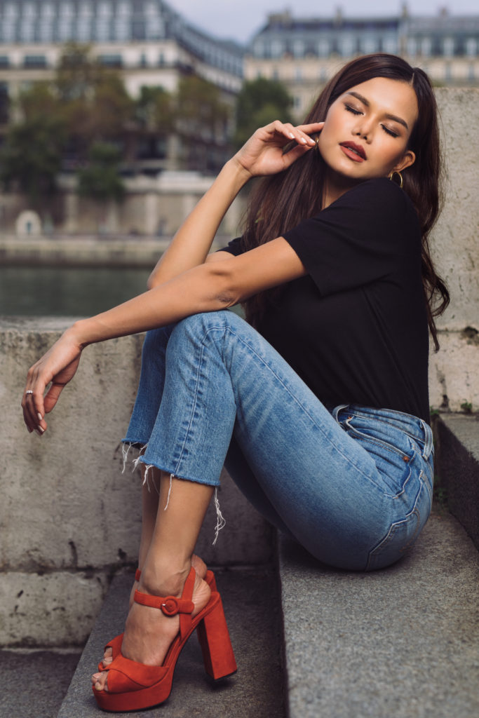 Woman wearing red shoes blue jeans posing in Paris