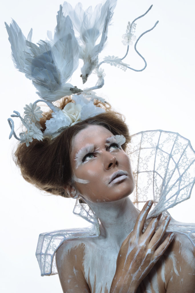 Miss white wearing dove headdress, creative photography